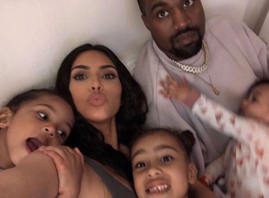 Kim Kardashian and Kanye West pose with all three kids