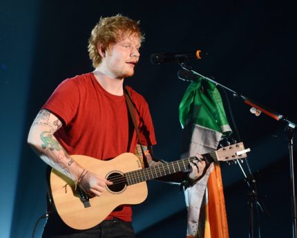Ed Sheeran performing in t-shirt.