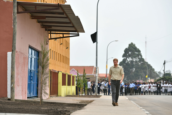 Prince Harry walks along Diana Road in Huambo