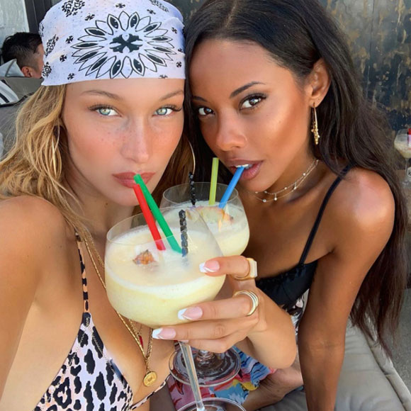 Bella Hadid enjoys a drink with friend, Fanny Bourdette-Donon, on vacation!