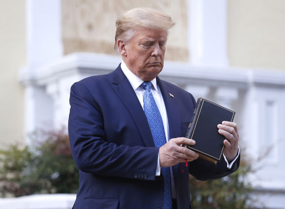 Donald Trump holding up a Bible.