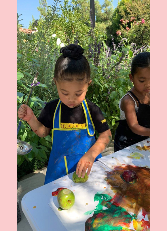 Stormi Webster wears a pink Hermès Kelly backpack to her first day