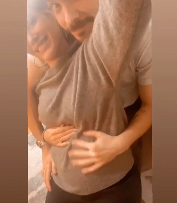 Hilary Duff and husband Matthew Koma show off the actress' growing baby bump.