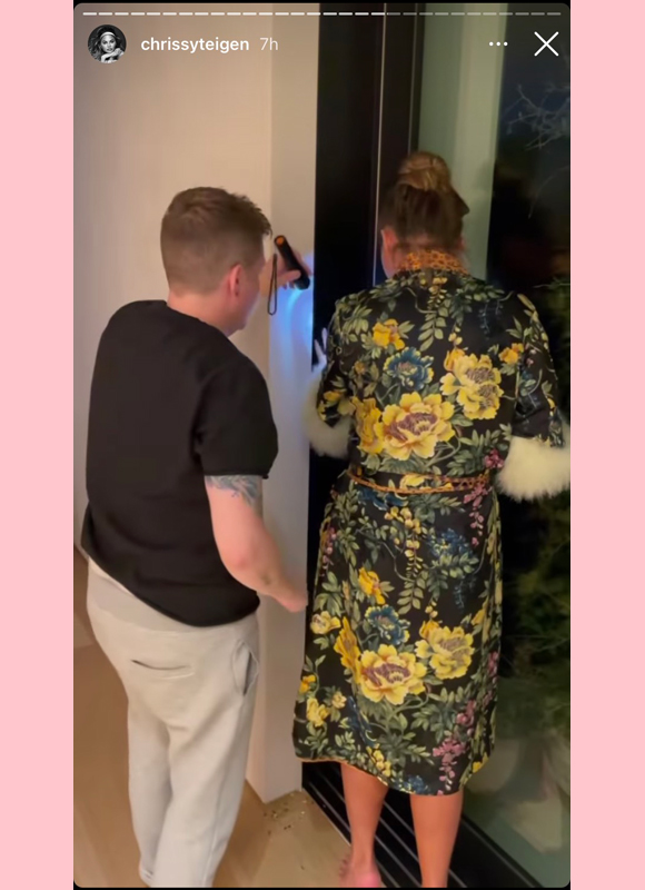 chrissy teigen : examines wall for hamster instagram story