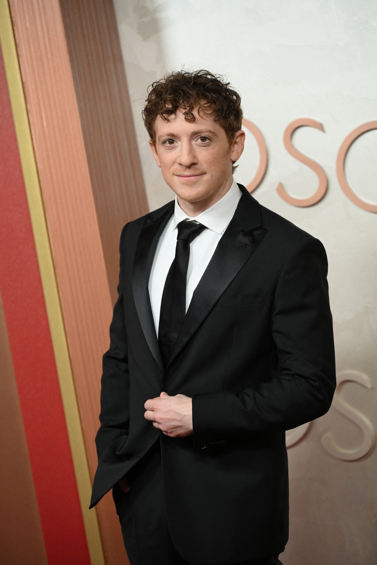 Ethan Slater walks the 2025 Oscars red carpet