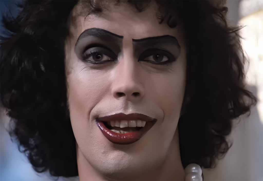 Tim Curry Throwback Interview: Watch Him Describe The 'Grisly' Role He Made Iconic In The Rocky Horror Picture Show